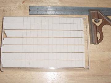 The tape marks where the holes are to be drilled in the spokes.